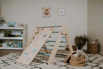 Kind rutscht über die Rampe des Pikler Kletterdreiecks im Kinderzimmer