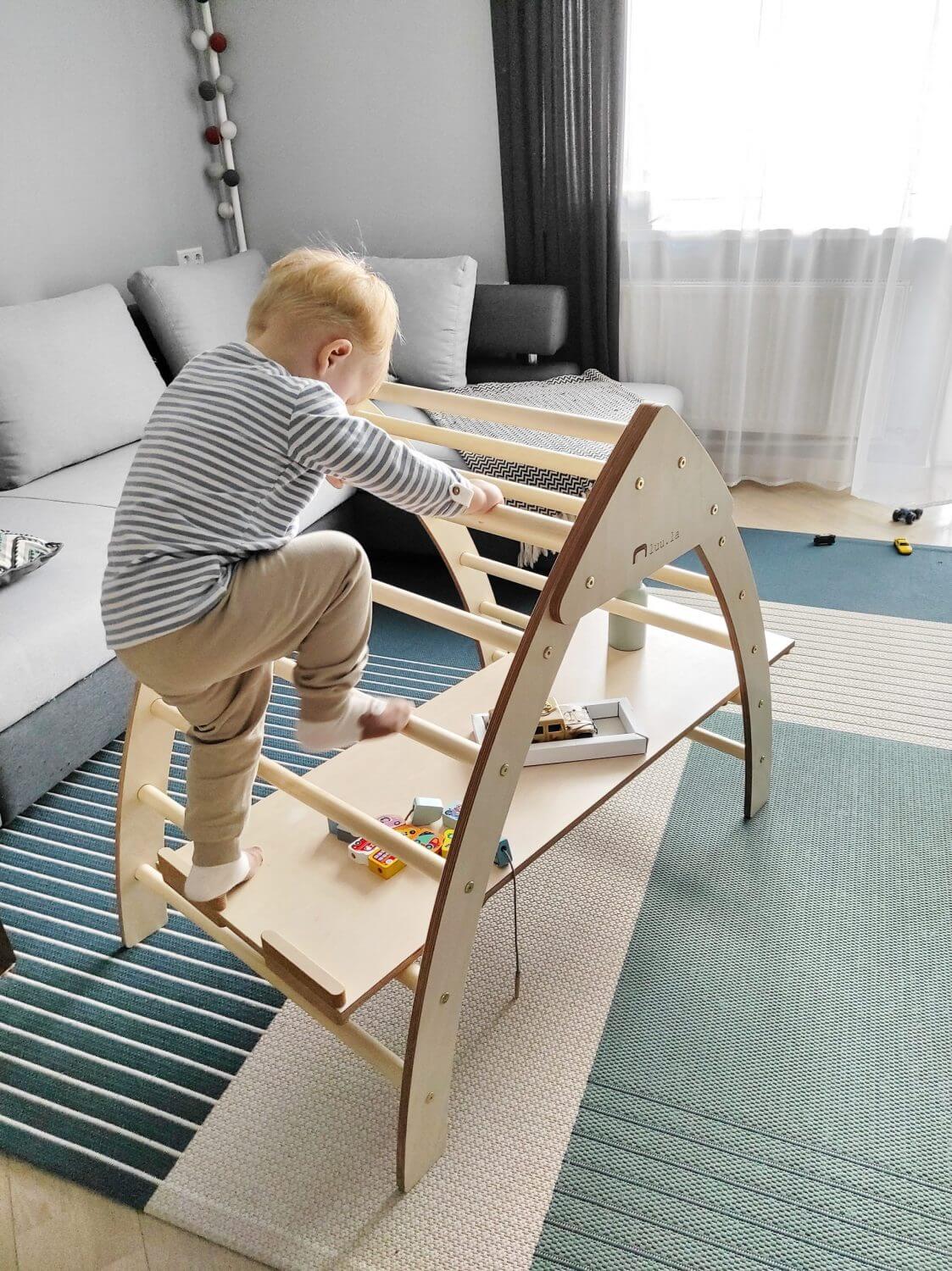 Kind rutscht über die Rampe des Trekant-Bergsteiger im Kinderzimmer